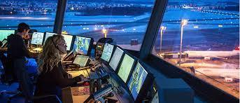 Air traffic controllers at work in a control tower at night