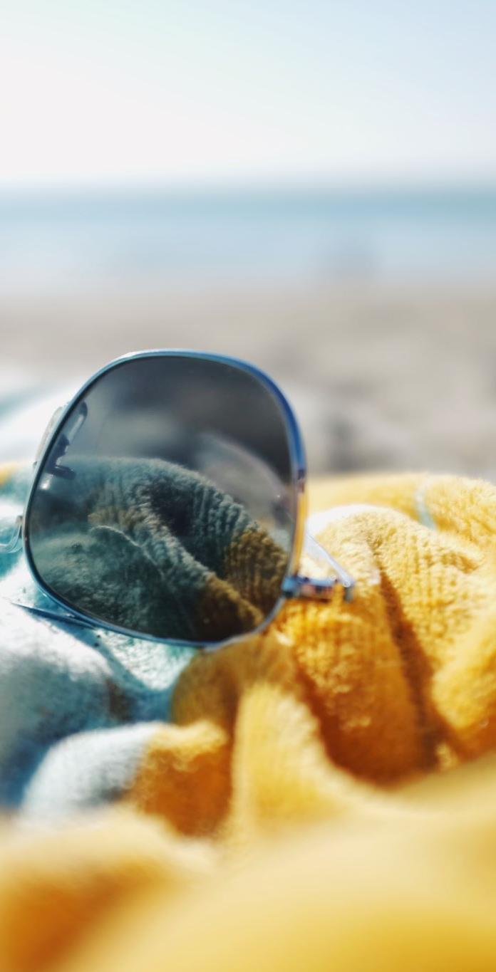 Sunglasses on a beach towel