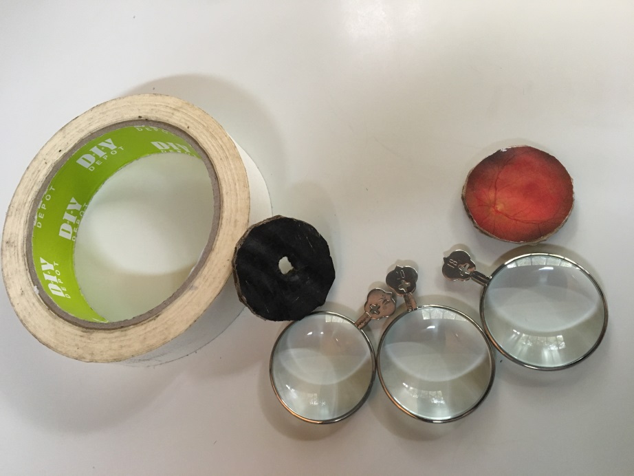 Masking tape, three high plus lenses, a black cardboard pupil disc and a fundus image disc