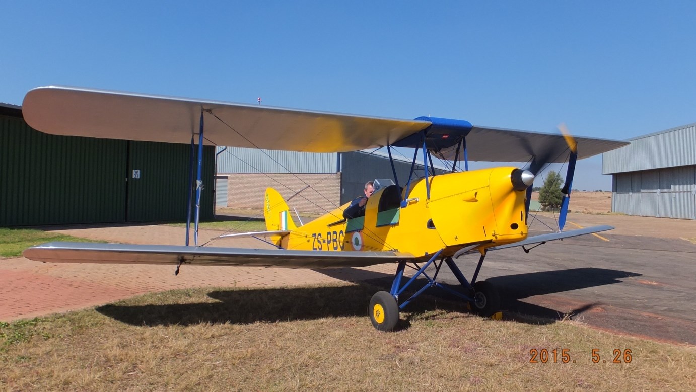 Yellow vintage biplane on an airfield